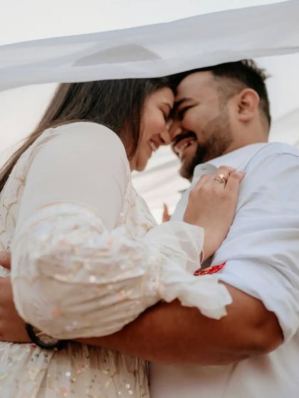 A happy, intimate embrace that perfectly captures the couple's love and excitement for their future together.
