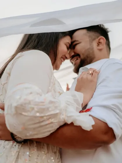 A happy, intimate embrace that perfectly captures the couple's love and excitement for their future together.
