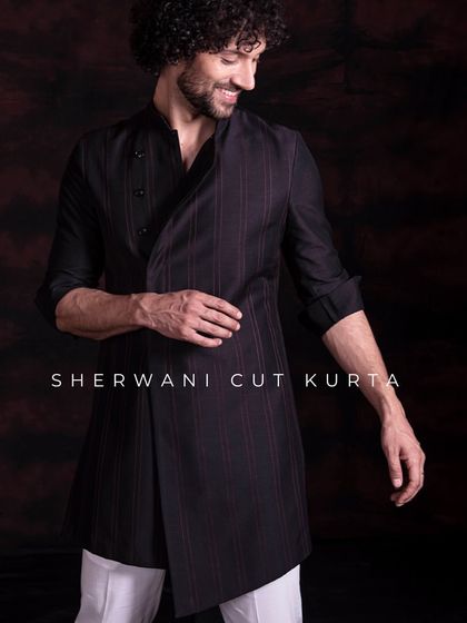 A sherwani-cut kurta in a black pinstripe fabric. This piece exudes refined style, with its asymmetrical cut and luxurious feel, offering a classy and modern look.