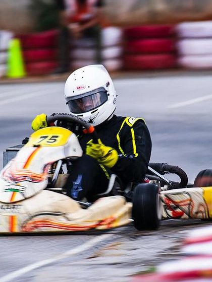 Our driver in the number 75 kart, pushing hard in tricky, wet conditions.