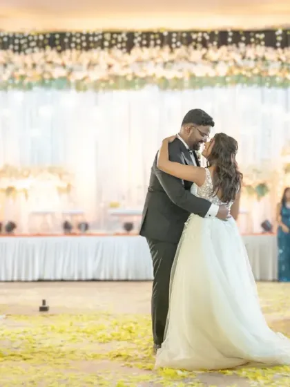 The first kiss as the dance begins. This is a classic, romantic moment that marks the start of the couple's life together, captured beautifully during their first dance.
