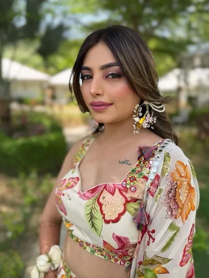 A portrait of the bride at her outdoor Haldi ceremony. The makeup is fresh and radiant, perfect for a sunny day celebration.