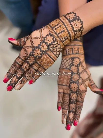 A classic jaali or net pattern, decorated with floral borders. This is a timeless design that is perfect for any festive occasion.