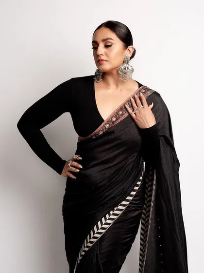 Another angle of the black JJ Valaya saree, showing the sleek silhouette and the striking border detail.