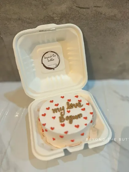 A heart-shaped bento cake with the message "my love Begun," perfect for celebrating the start of a new relationship or a special anniversary.