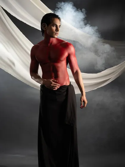 Body painting is a powerful way to tell a story. For this conceptual shoot, I used bold red body paint to create a striking, mythological character, sculpting with color and shadow.