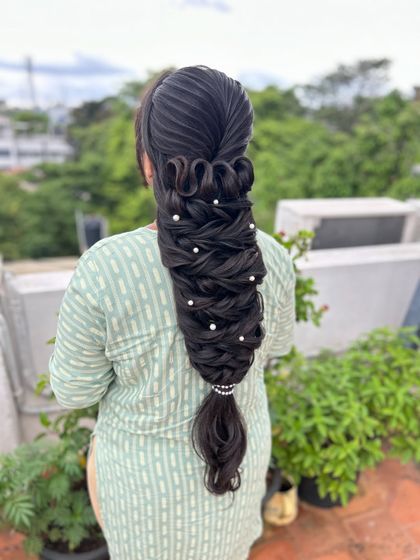 Another angle of the advanced, sculptural braid with pearl accents, a true work of art.