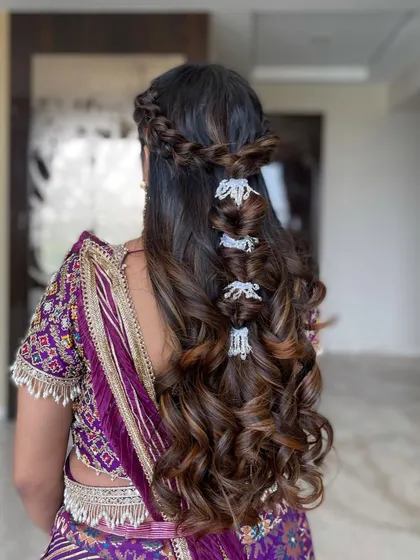 A still shot of the intricate half-updo with multiple braid types and accessories.