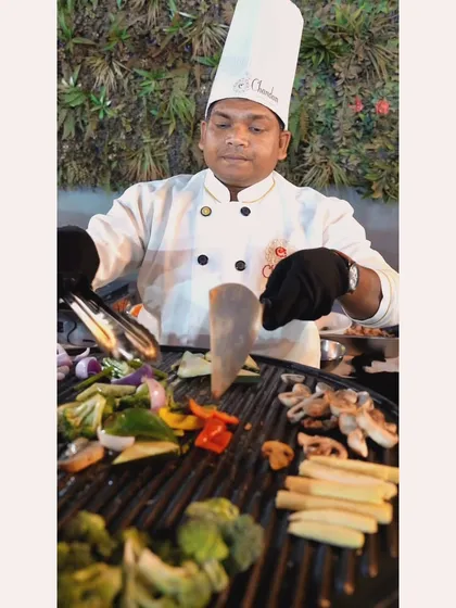 Our chef expertly grilling a colorful assortment of fresh vegetables for the 'Grillax Gourmet' dish. This live station offers a healthy yet incredibly flavorful option for guests.