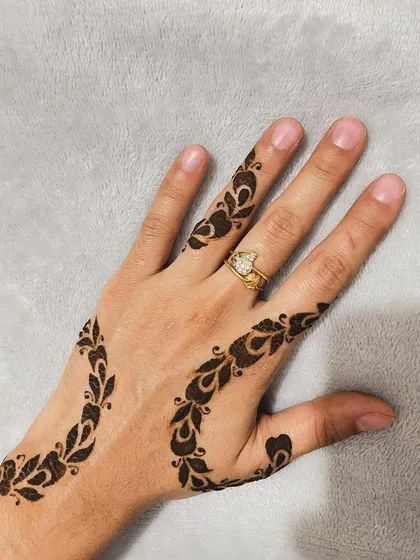 A clear shot of the delicate swirling vine pattern on a light background.