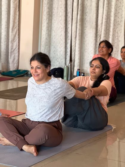 In our community, we learn by helping each other. Here, students practice partner stretches to better understand anatomy and flexibility.