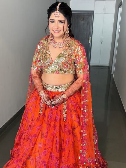 A full view of Rashmi's stunning Haldi look. The makeup is bold enough to match the bright colors of her outfit, creating a cohesive and beautiful ensemble.