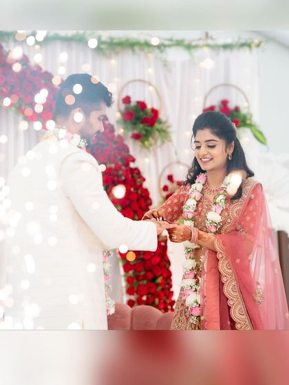 A close-up of the ring exchange, one of the most important moments. Our decor, with its rich red roses and soft lighting, provides the perfect frame for these precious memories.