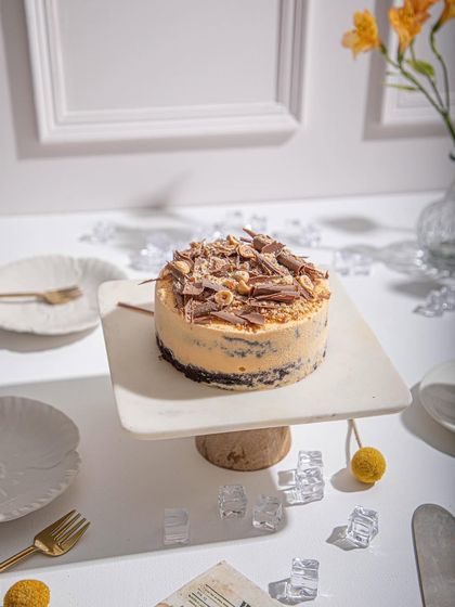A full view of our Mango & Chocolate Ice Cream Cake, beautifully presented on a modern cake stand. It's a perfect centrepiece for any celebration.