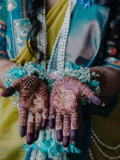 A close up of a baby shower mehendi, showing the beautiful stain. This design features a portrait of the mother and child, a very personal touch for the celebration.