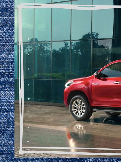 A creative shot of the Toyota Hilux, framed by a denim texture, visually linking the ruggedness of the vehicle with the classic durability of denim.