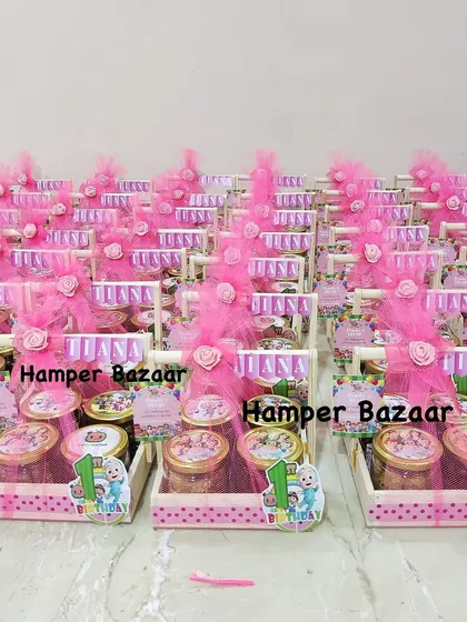 A bulk order of Cocomelon themed first birthday hampers for Tiana, all decked out in pink.