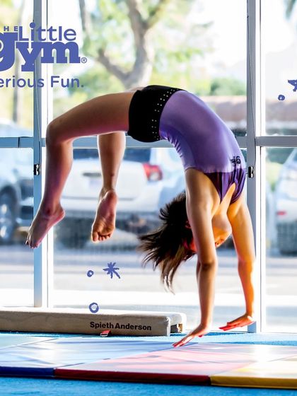 A gymnast executes a perfect backbend on the beam, showcasing flexibility and strength. Our programs prepare kids to be 'Whatever Ready' for any challenge that comes their way.