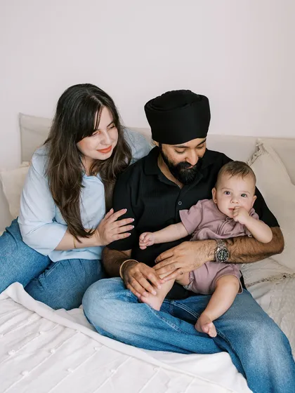 A family portrait from the seven-month session, showing the baby sitting comfortably on his dad's lap.