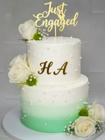 This two-tier engagement cake features a beautiful mint green ombre design. To satisfy different tastes, the bottom tier is fresh pineapple and the top is choco-vanilla, all 100% eggless and homemade.