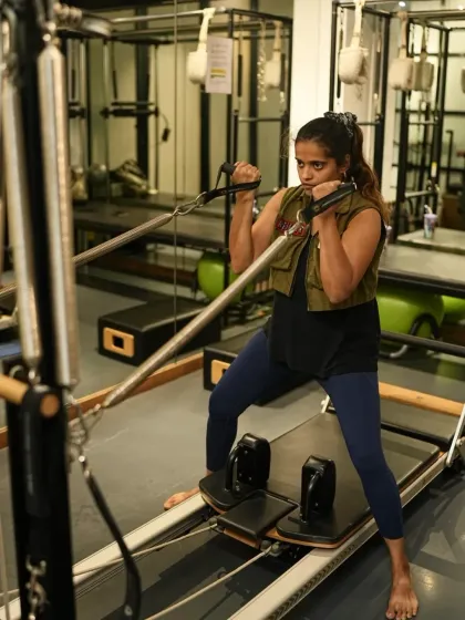 Here, a client uses the reformer for a standing arm exercise. This is intelligent movement that trains the muscles you don't normally use while strengthening the ones you rely on every day.