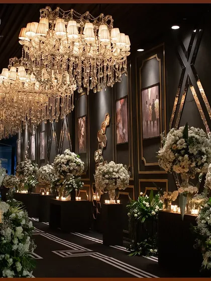 The grand chandelier-lined entrance, showing how the repetition of lighting elements can create a powerful sense of scale and luxury.