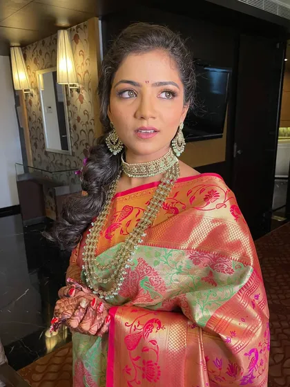A side profile showing the intricate details of the hairstyle and jewelry.