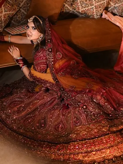 A dramatic pose that highlights the rich fabric and heavy embroidery of the bridal lehenga. I use posing to create movement and energy, making the outfit feel alive and dynamic.