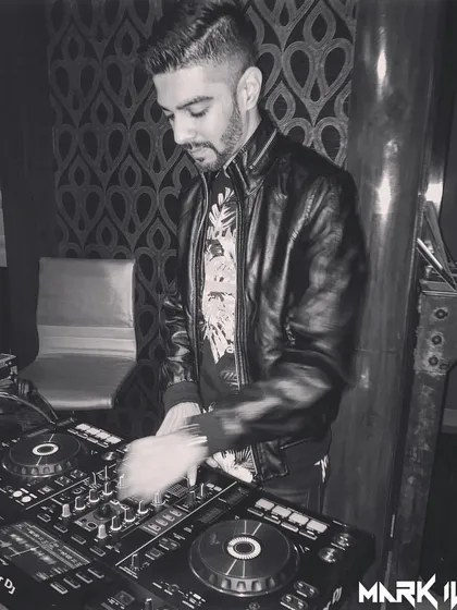 A black and white photo from a gig, showing my hands in motion on the mixer. This captures the technical side of my work, constantly adjusting and fine-tuning the sound to create the perfect mix.