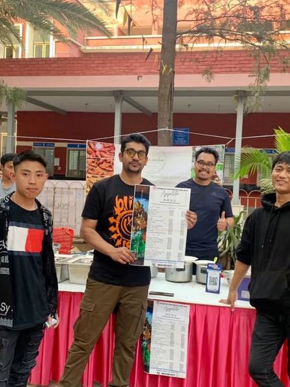 Posing with some cheerful visitors at my food stall during a college fest.
