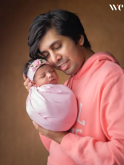 These are the moments to cherish. We love capturing the special bond between a father and his newborn child, creating a tender and emotional portrait.