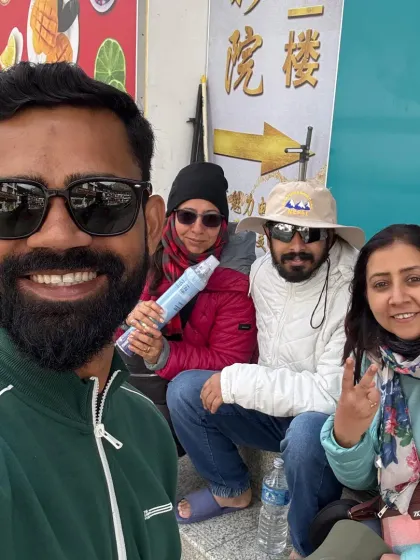 A group selfie during a break on our journey. We ensure everyone is comfortable, carrying essentials like portable oxygen for the high altitudes.