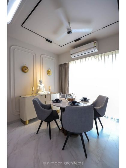 The dining area in the 'Atmosphere' project, featuring a serene Buddha statue and elegant wall sconces. This space is designed to be a calm, mindful corner for family meals.