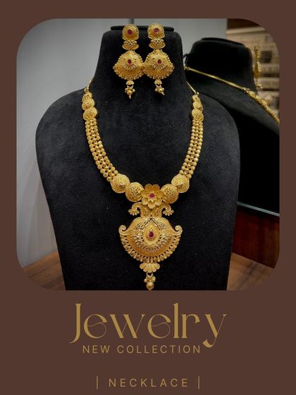 A beautiful 1-gram gold necklace set with a traditional pendant and matching jhumkas. The ruby-colored stone adds a touch of color to the piece.