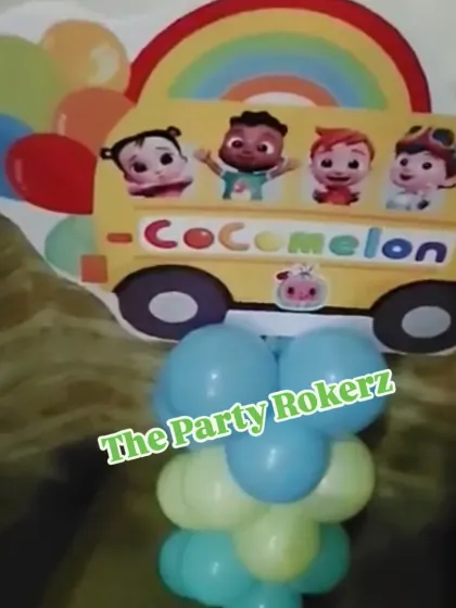 A Cocomelon-themed balloon pillar with a character cutout on top. These are great for decorating entrances or placing around the party venue.