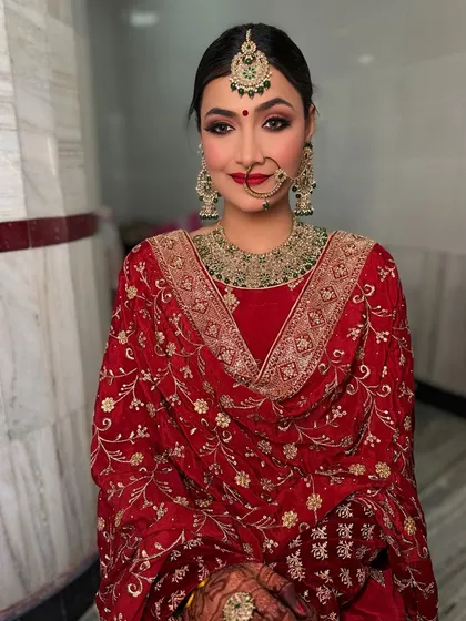 My beautiful bride Shweta for her Anand Karaj look. The bold red lip and defined eyes are a perfect match for her traditional and vibrant outfit.