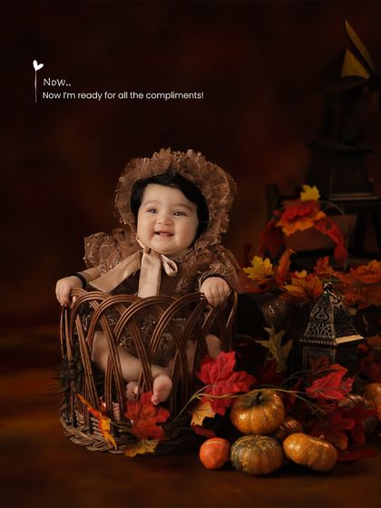 A wide shot of the autumn-themed setup, complete with pumpkins, fall leaves, and a rustic lantern, creating a cozy and festive atmosphere.