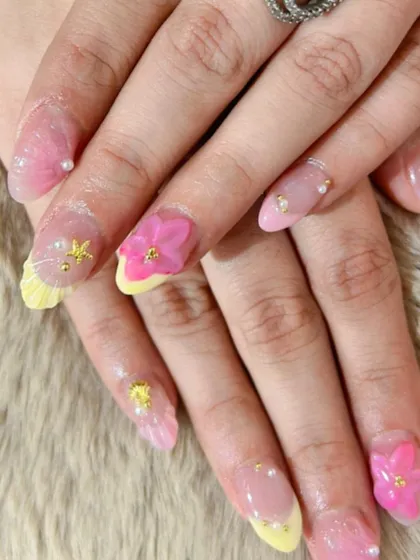 A playful, mermaid-inspired set with 3D flowers, starfish, and pearl details on a pink and yellow base.