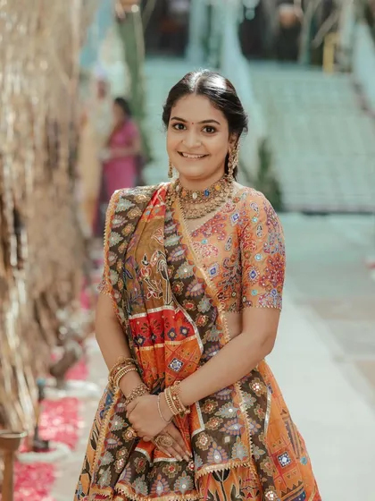A portrait of the client, her hair styled elegantly for the traditional pooja.