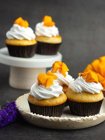 Capturing the taste of summer with my fresh mango cupcakes. A light vanilla cupcake topped with whipped cream and sweet, juicy mango pieces.