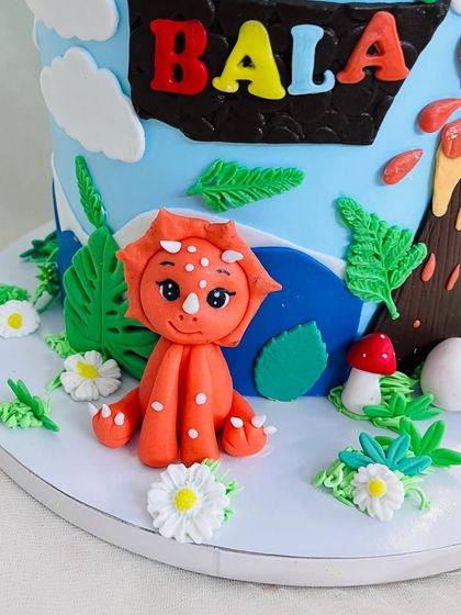 A close-up of the cute, orange triceratops I sculpted for the dinosaur-themed cake.