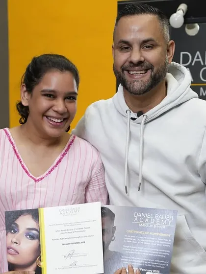 At our academy, the finish line is just the beginning. A proud graduate receives her certificate from Daniel Bauer after completing the 12-week course.