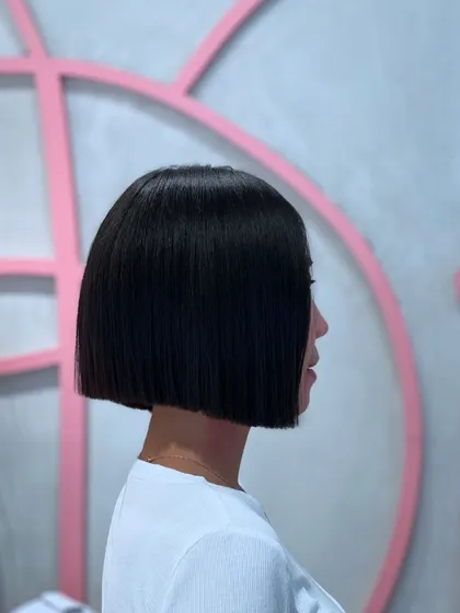 Another angle of the perfectly executed blunt bob. The line is razor-sharp, showcasing the precision and skill that goes into a seemingly simple cut.
