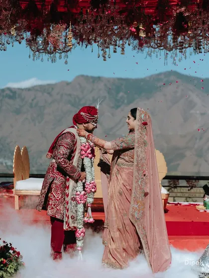 Amidst the serene majesty of the Mussoorie hills, two souls become one. The exchange of garlands is a pivotal moment, and I frame it against the epic landscape to signify that their love is as vast and enduring as the mountains themselves. This is where nature bears witness to forever.