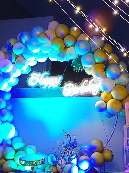 A beautiful shot of the ring balloon decoration under dramatic lighting. We use a mix of pastel and chrome balloons to create a sophisticated and modern look.