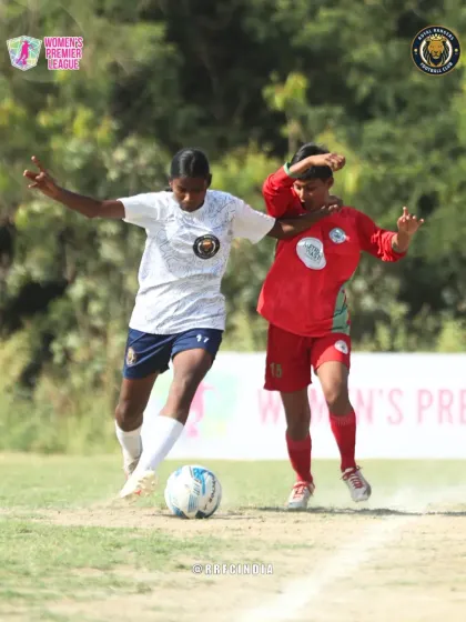 Our player uses her body to shield the ball effectively from a defender, demonstrating excellent physical play and ball protection skills.
