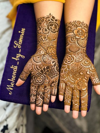 A close-up of the palms, showing the beautiful floral mandala and the intricate details on the fingers.