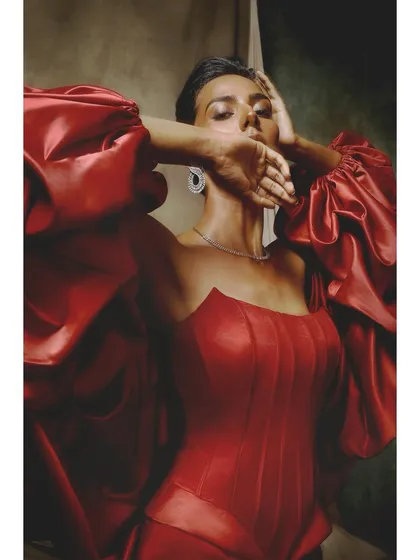 A closer portrait from the same look for Ambika Lal. This angle highlights the gown's structured corset and the model's expressive pose, blending vulnerability with strength.