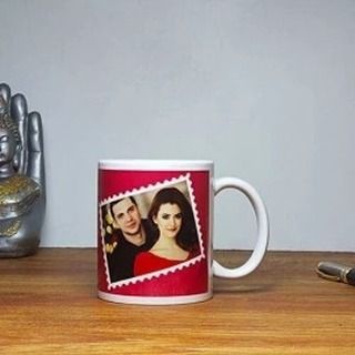 This personalized mug features a photo of a couple printed in a stamp-like design. It's a simple and sweet way to keep a memory close during your daily coffee or tea.