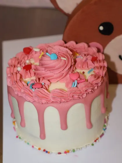 The perfect companion to our teddy bear cake is this mini drip cake, covered in pink frosting, sprinkles, and swirls.